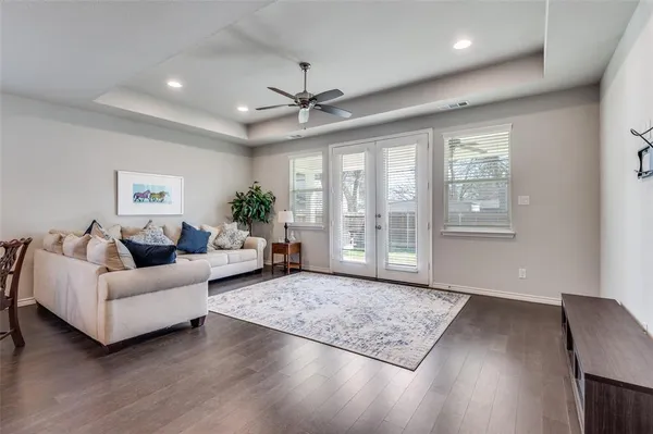 a living room with furniture and wooden floor