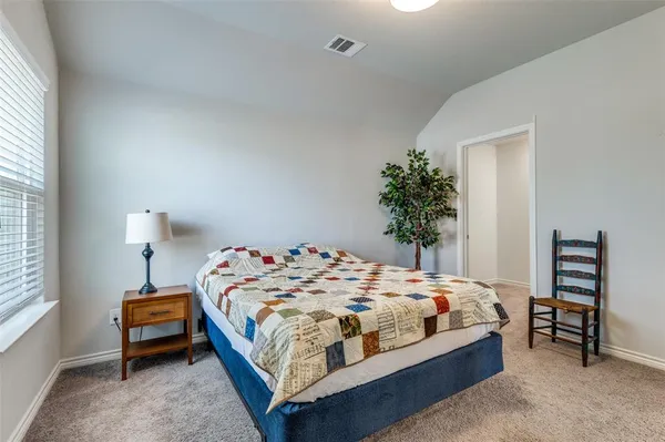 a bedroom with a bed and a chair