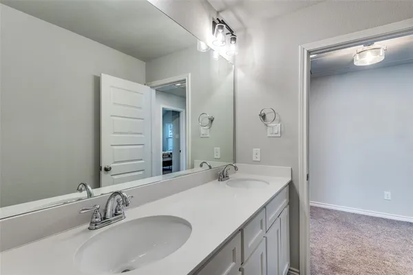 a bathroom with a double vanity sink and a mirror