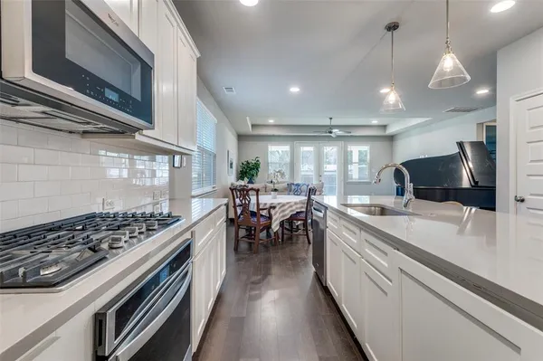 a kitchen with stove and cabinets