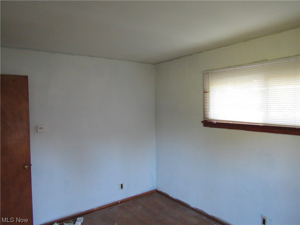 6986 Reed Road Conneaut, OH 44030 - Photo 16 of 22 Unfurnished room featuring dark hardwood floors