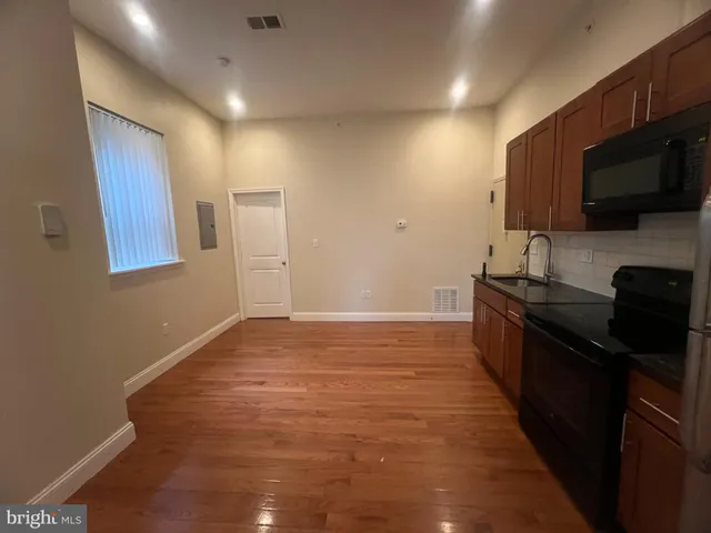 a kitchen with a sink and steel appliances