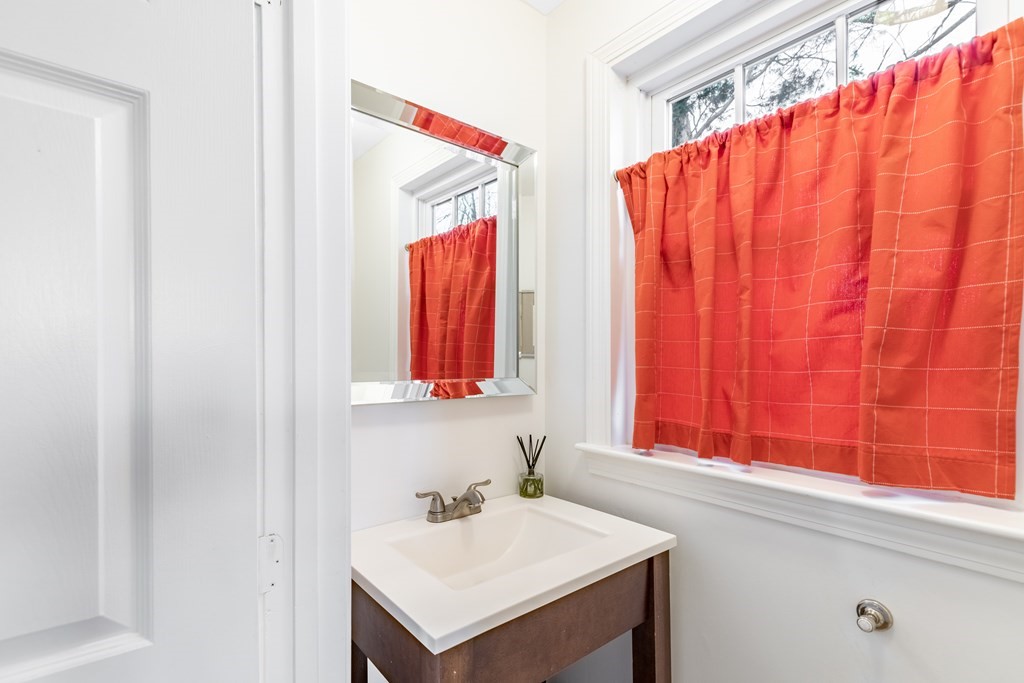4 Abernathy Way Marblehead, MA 01945 - Photo 11 of 28 a bathroom with a sink and a mirror