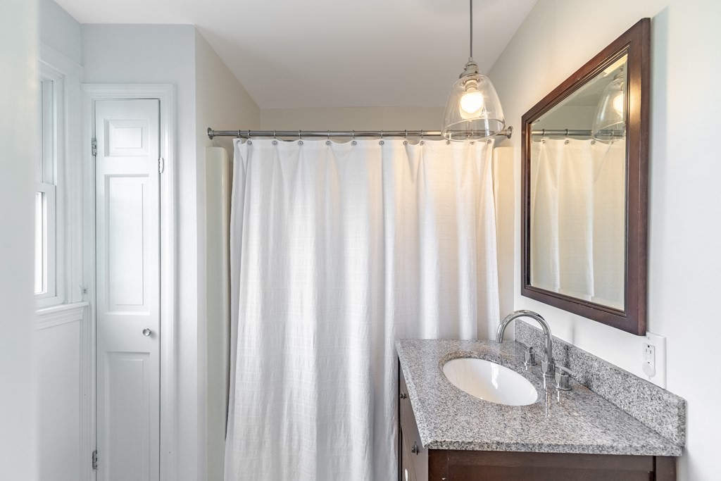4 Abernathy Way Marblehead, MA 01945 - Photo 13 of 28 a bathroom with a granite countertop sink and a mirror