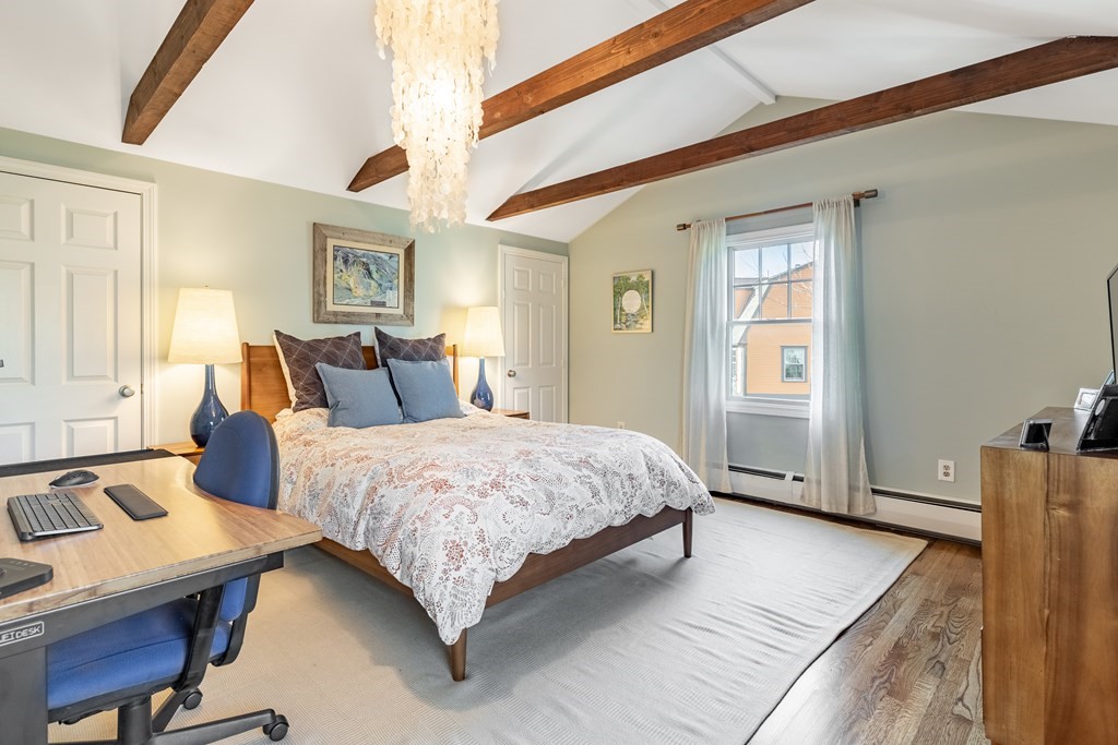 4 Abernathy Way Marblehead, MA 01945 - Photo 17 of 28 a bedroom with a bed a table and chair