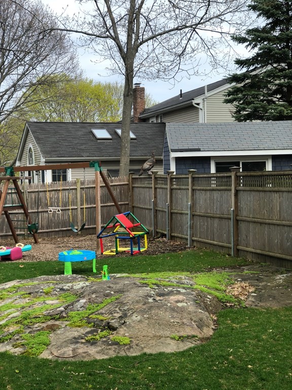 4 Abernathy Way Marblehead, MA 01945 - Photo 24 of 28 a view of a backyard with a small cabin and a chair
