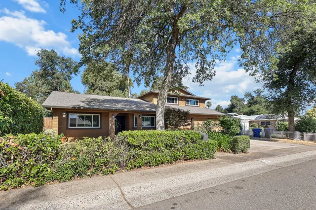 an aerial view of house with yard and trees around