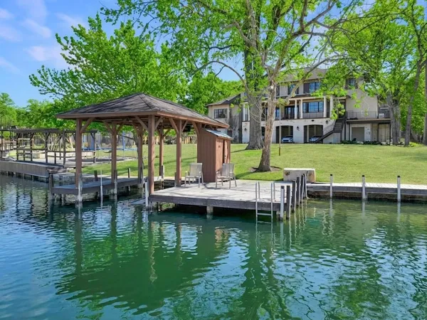 a view of swimming pool with lawn chairs and plants