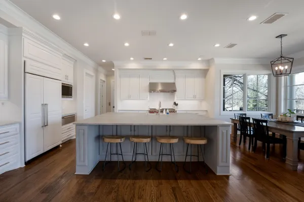 a kitchen with kitchen island granite countertop wooden floors and center island