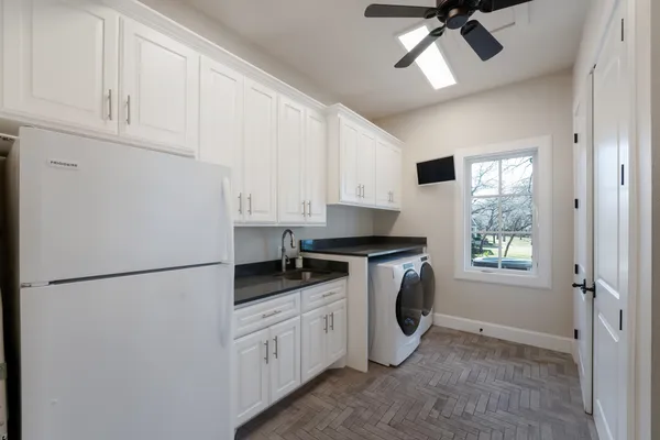 a kitchen with stainless steel appliances a refrigerator sink and cabinets
