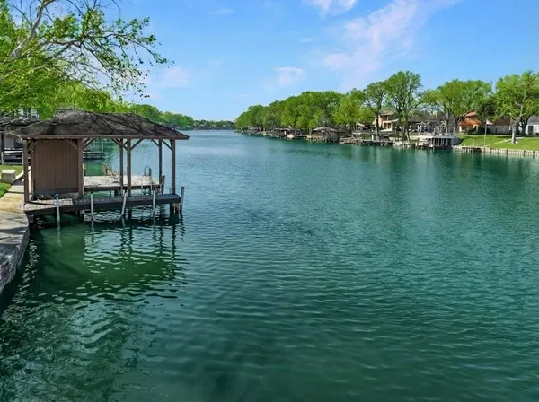 a view of a lake with table and chairs