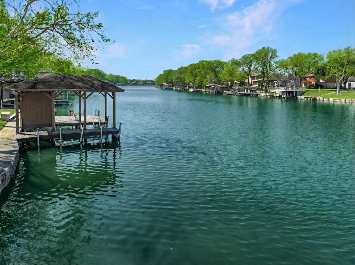 232 Laguna Rio Seguin, TX 78155 - Photo 2 of 30 a view of a lake with table and chairs