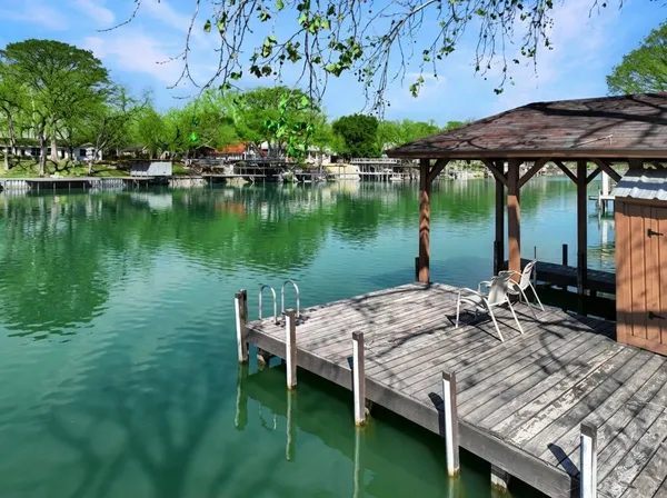a view of a wooden deck with furniture and garden