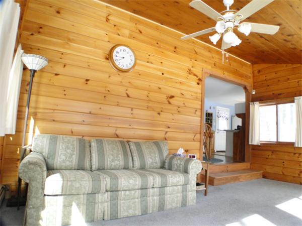 16 Herring Run Road Sandwich, MA 02537 - Photo 17 of 29 a living room with a couch and a clock on the wall