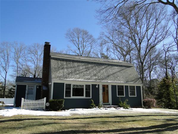 16 Herring Run Road Sandwich, MA 02537 - Photo 2 of 29 a front view of a house with a yard table and chairs
