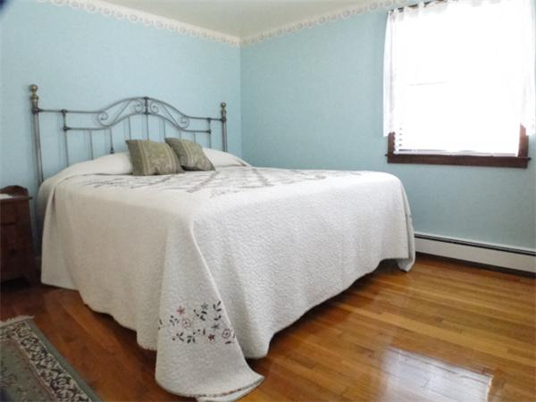 16 Herring Run Road Sandwich, MA 02537 - Photo 21 of 29 a bedroom with a bed and wooden floor