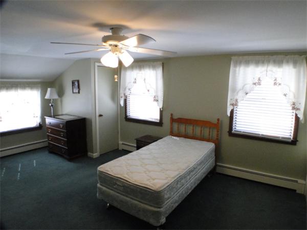 16 Herring Run Road Sandwich, MA 02537 - Photo 24 of 29 a bedroom with a bed and a chandelier