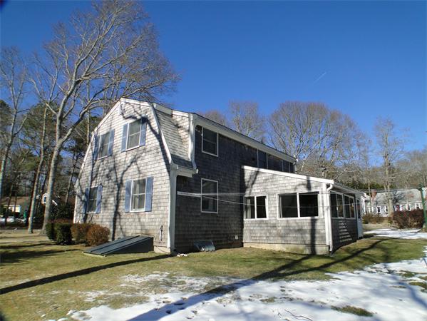 16 Herring Run Road Sandwich, MA 02537 - Photo 5 of 29 a view of a white house with a large tree and a yard