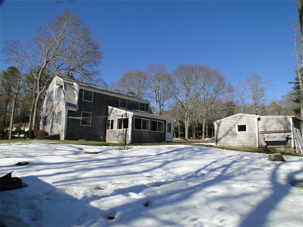 16 Herring Run Road Sandwich, MA 02537 - Photo 6 of 29 a white house that has a tree in front of it