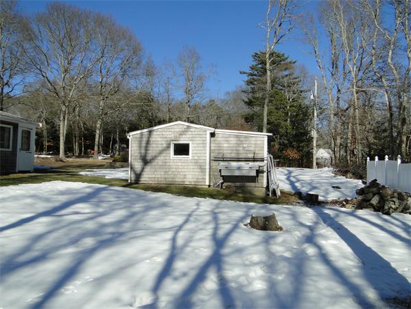 16 Herring Run Road Sandwich, MA 02537 - Photo 7 of 29 a view of a white house with a yard