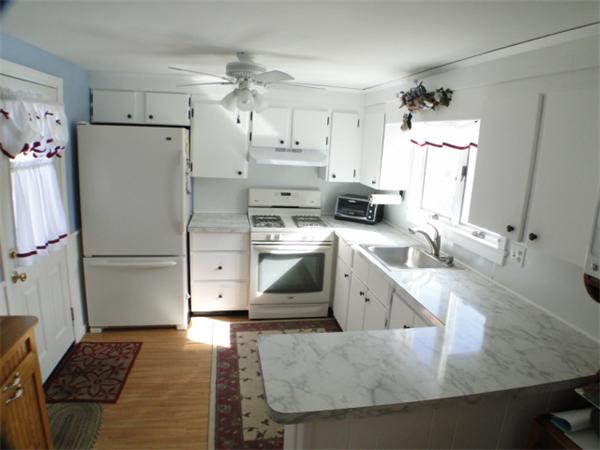 16 Herring Run Road Sandwich, MA 02537 - Photo 10 of 29 a kitchen with a sink a stove a refrigerator and cabinets