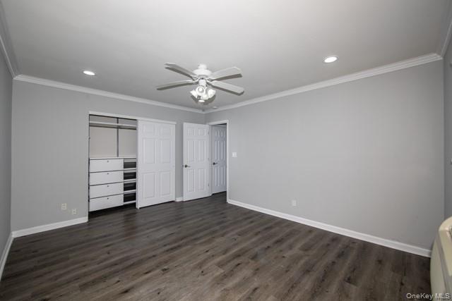 65 Friendly Court, Unit FC65 Babylon, NY 11702 - Photo 6 of 8 a view of an empty room with a window and wooden floor