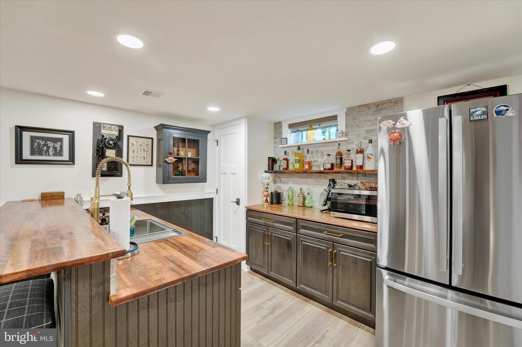 147 Elkmore Road Elkton, MD 21921 - Photo 31 of 52 Wet Bar with Cabinetry & Stacked Stone Backsplash