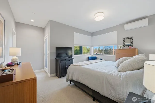 a bedroom with a bed and a flat tv screen