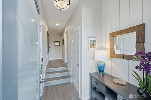 a view of hallway with furniture and wooden floor
