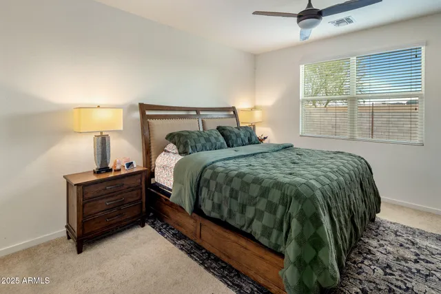 a bedroom with a bed and a lamp