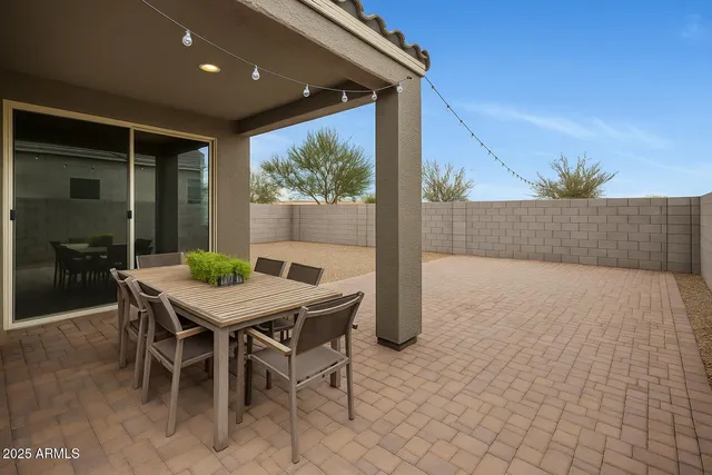 a view of an outdoor dining space with a table and chairs