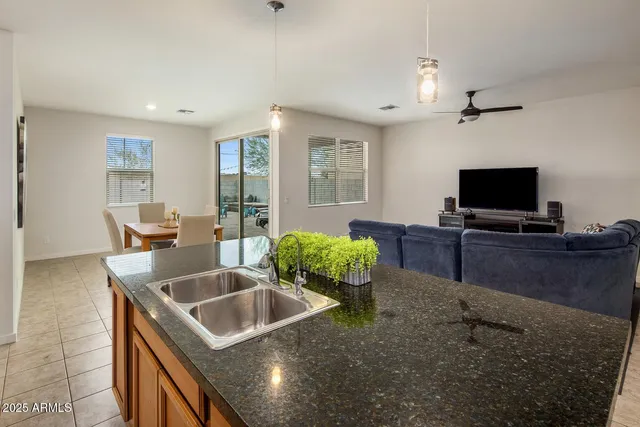 a kitchen with sink stove and refrigerator