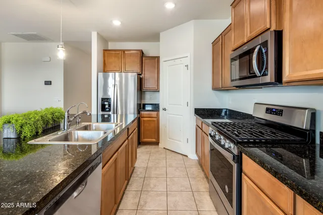 a kitchen with granite countertop stainless steel appliances lots of counter top space