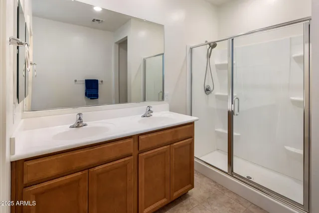 a bathroom with a shower sink and mirror