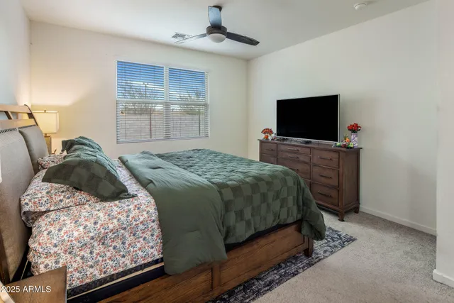 a bedroom with a bed and a television
