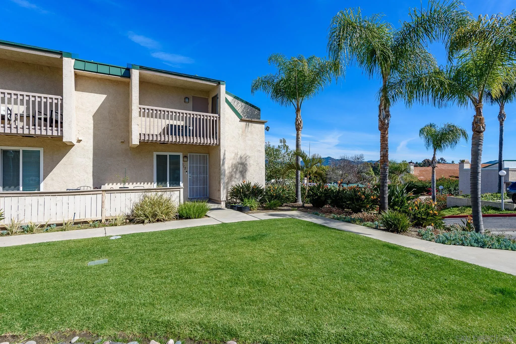 712 Silver Drive Vista, CA 92083 - Photo 2 of 32 a front view of a house with a garden and yard