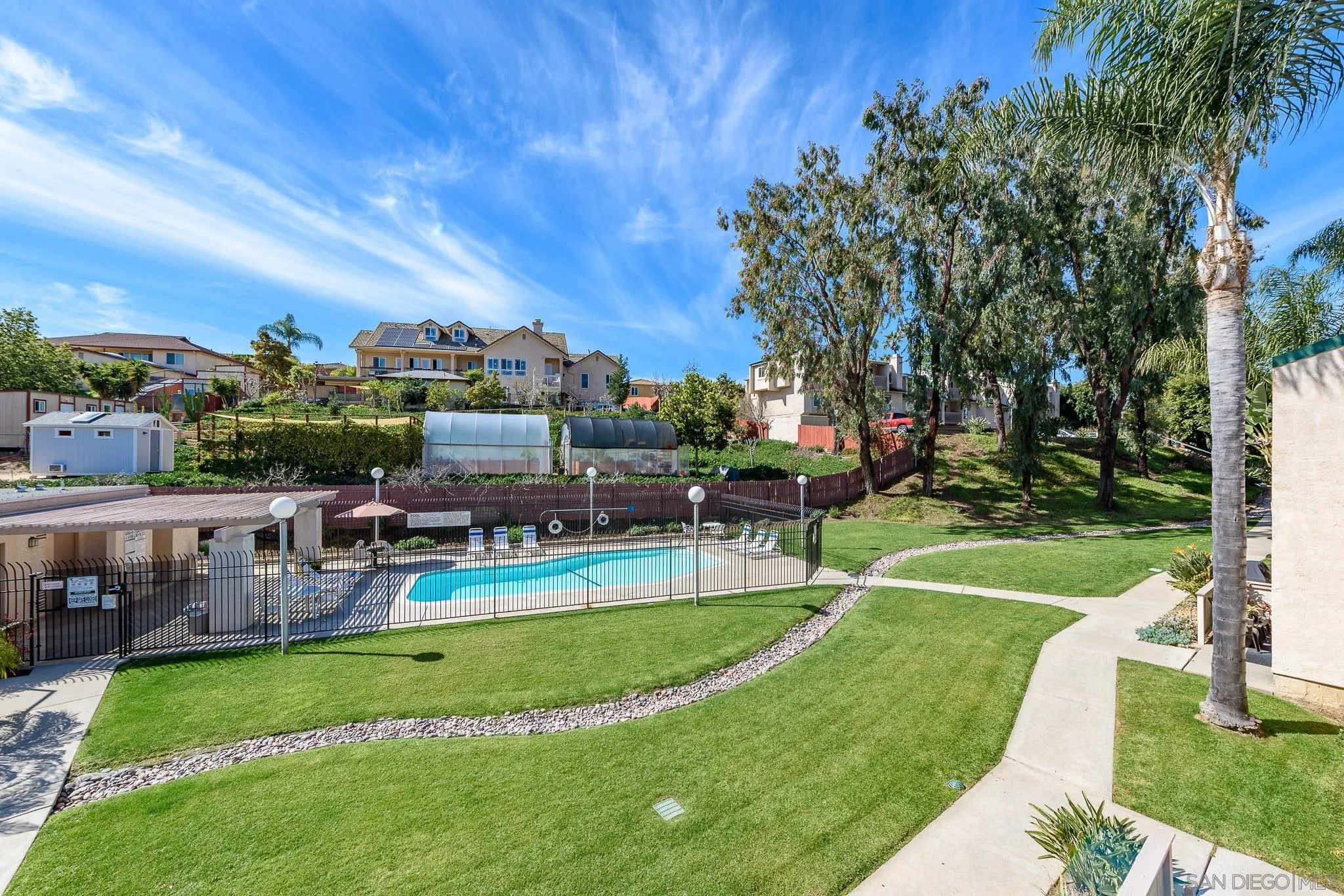 712 Silver Drive Vista, CA 92083 - Photo 28 of 32 a view of a swimming pool with lawn chairs and a big yard