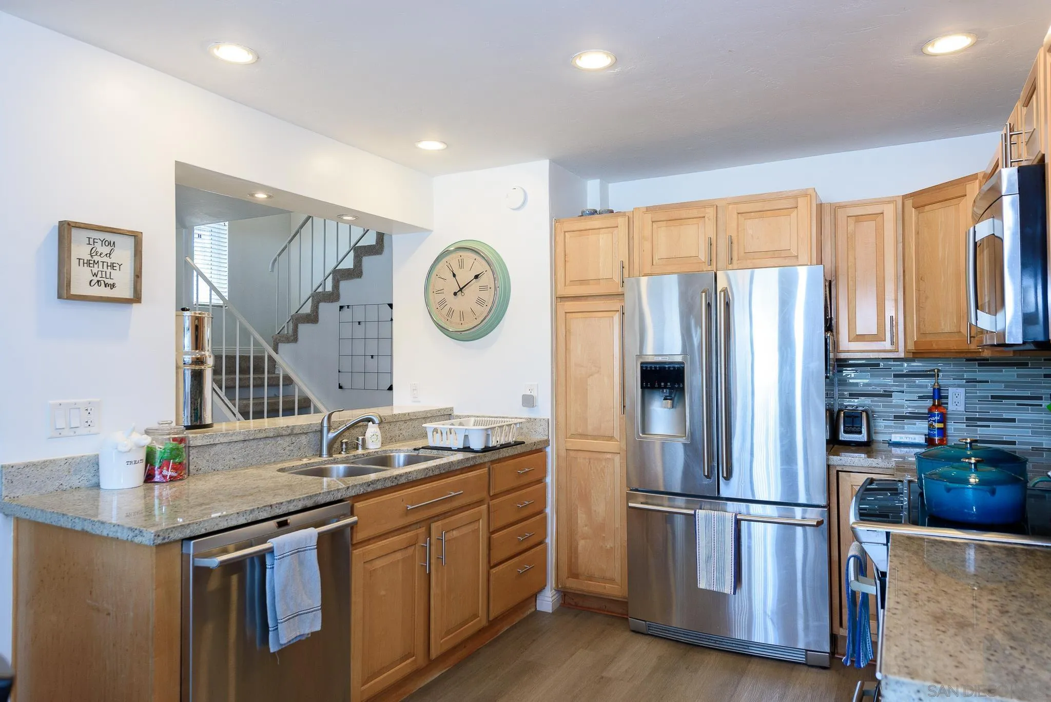 712 Silver Drive Vista, CA 92083 - Photo 32 of 32 a kitchen with stainless steel appliances granite countertop a refrigerator a stove and a sink