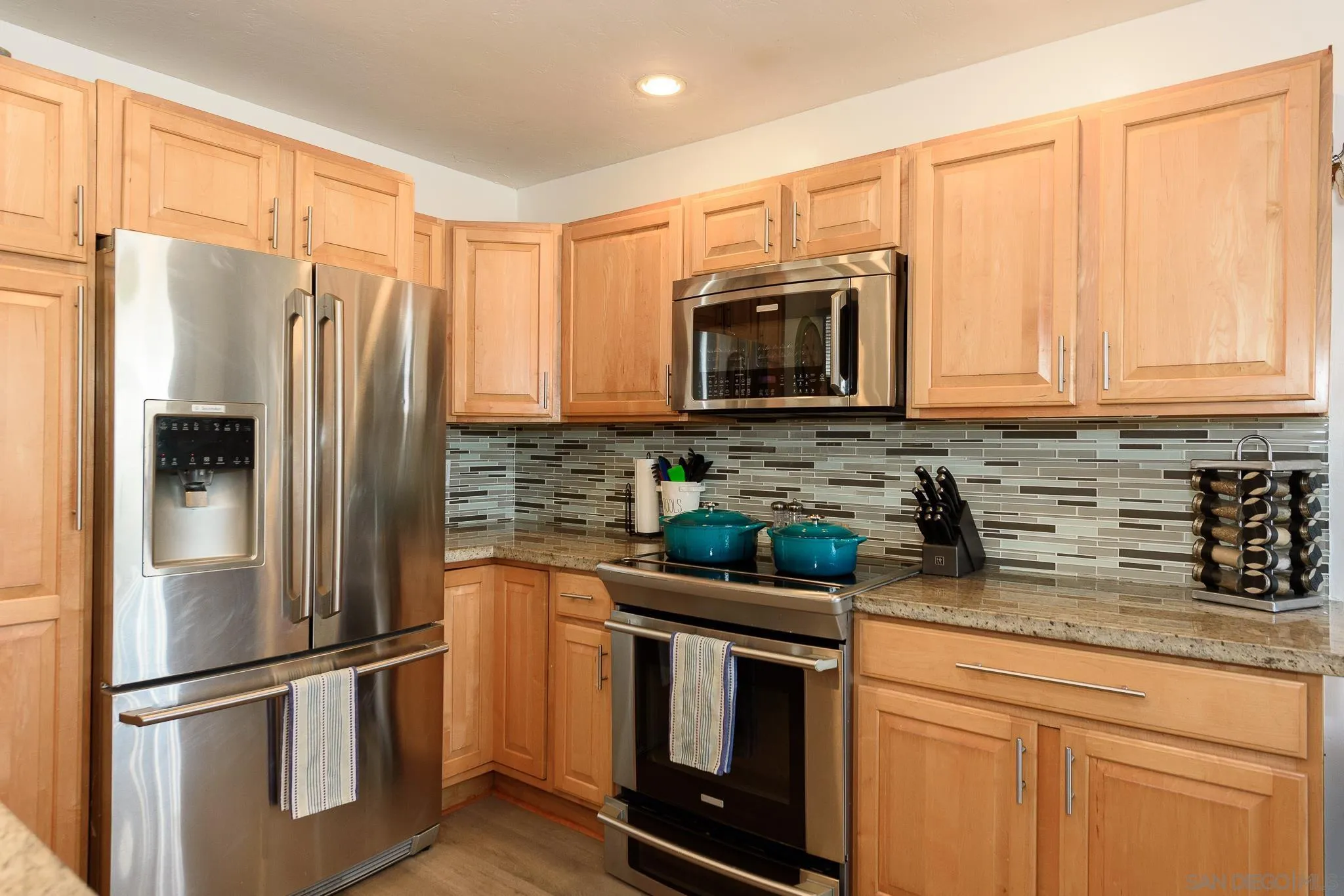 712 Silver Drive Vista, CA 92083 - Photo 10 of 32 a kitchen with stainless steel appliances granite countertop a refrigerator stove and microwave