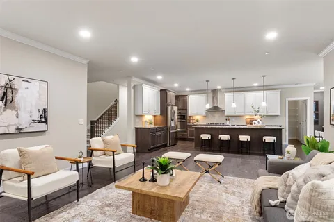a living room with furniture kitchen view and a table
