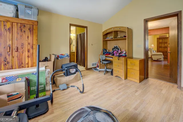 a living room with furniture and a dining table