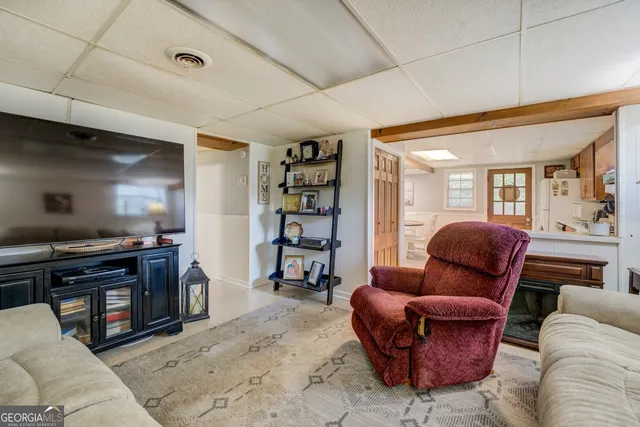 a view of a livingroom with furniture and staircase