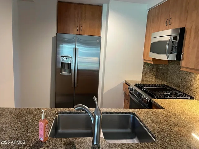 a kitchen with a refrigerator stove and microwave