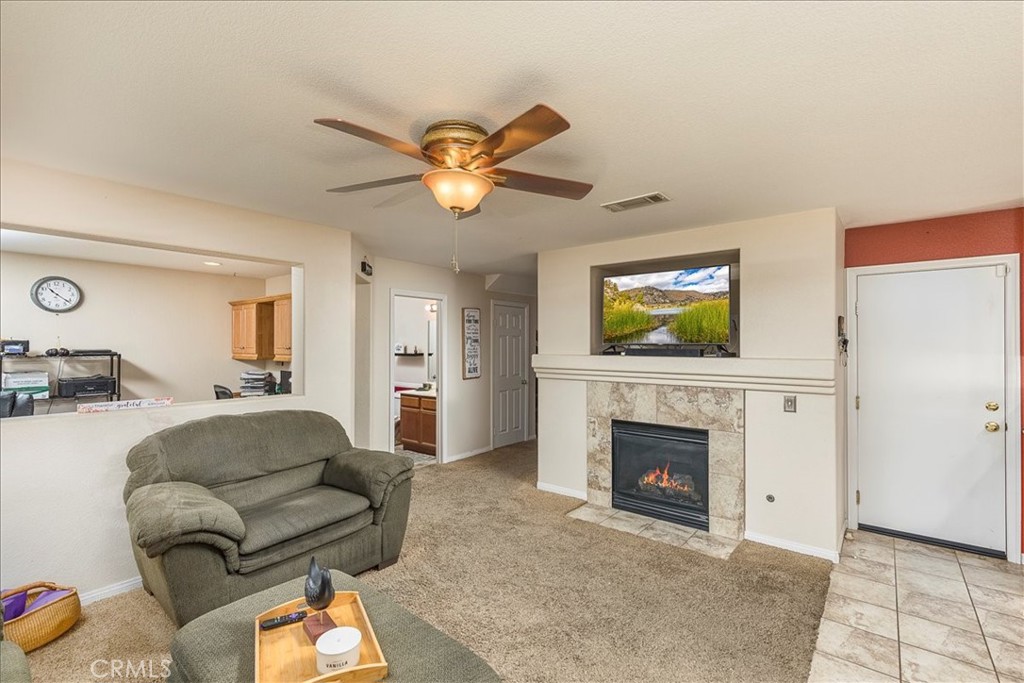 28984 Escalante Road Menifee, CA 92587 - Photo 10 of 40 Family room with fireplace and cutout to built-in office area