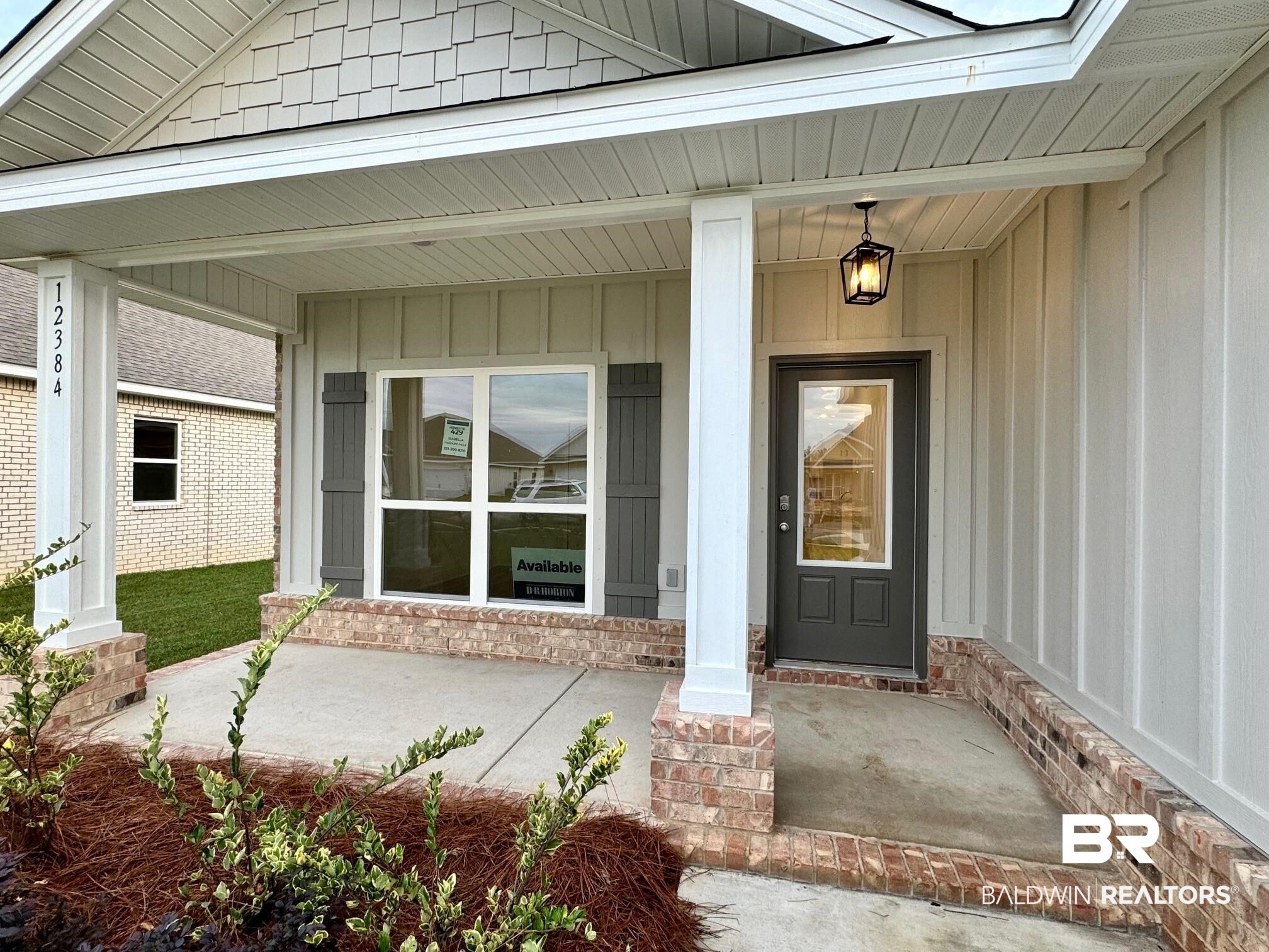View of exterior entry with covered porch