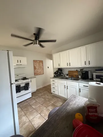 a kitchen with granite countertop a stove a sink dishwasher and a refrigerator