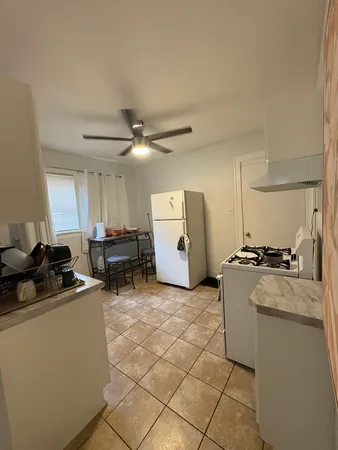 a kitchen with a sink a stove and cabinets