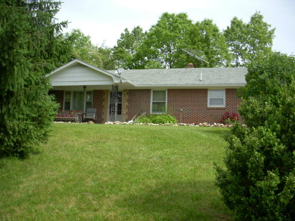 293 Huckleberry Ridge Road Northeast Floyd, VA 24091 - Photo 4 of 29 a front view of a house with a garden