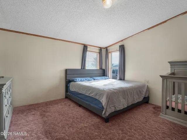 a bedroom with a bed next to a window