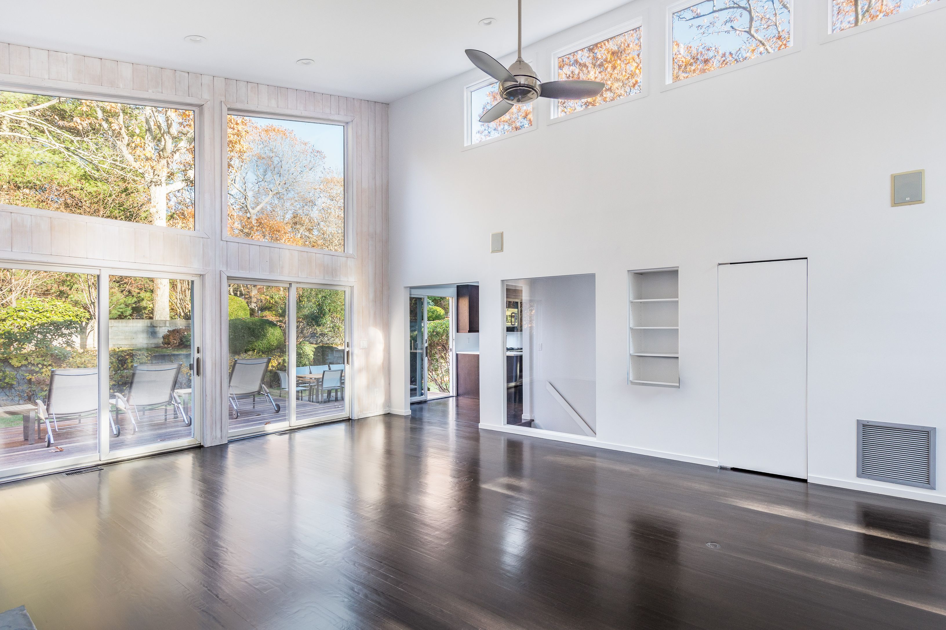 132 Springy Banks Road East Hampton, NY 11937 - Photo 16 of 35 a view of an empty room with wooden floor and a window